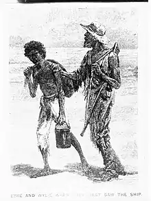 A dark-skinned man with a bucket and a man in a hat with a gun plod.