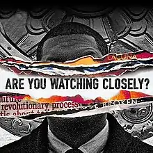 Jay Electronica with the words "Are you watching closely?" written across his face