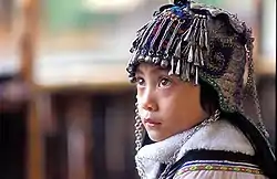 An ethnic Hani girl with the typical headgear for children