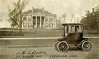 Advertising postcard (pre-1906) for the R&L Electric Car taken in front of the Leonard Hanna mansion on Euclid Avenue