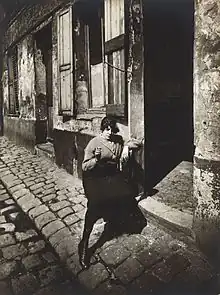 Prostitute waiting in front of her door, 1921