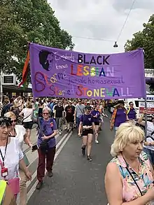 A parade banner that says "Everybody knows black lesbian female homosexual Stormé started Stonewall," Europride 2019, Vienna, Austria