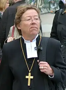 Bishop of Stockholm Eva Brunne wearing a cassock and a Lutheran clerical collar with preaching bands