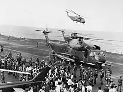 Evacuees offloaded onto USS Midway