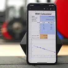 a smartphone with a spreadsheet showing details of an athletes strength training profile