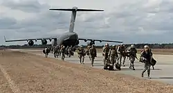 US Air Force personnel participating in Exercise Scorpion Lens 15 disembark a C-17 Globemaster III at North Auxiliary Airfield during 2015.