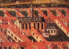 Detail of a painting showing a fairly high church in a city.