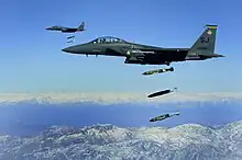 A U.S. Air Force F-15E Strike Eagle dropping 2000-pound munitions