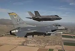 The 56th Operations Group flagship F-16 Fighting Falcon (84-1297) welcomes Luke Air Force Base's first F-35 Lightning II (11-5030) to the base 10 March 2014.