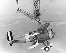 An F9C Sparrowhawk catches the trapeze aboard Macon in 1933