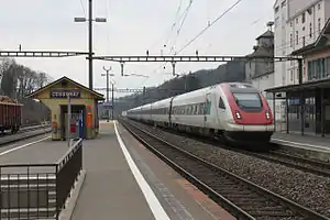 White-and-red train passes through station