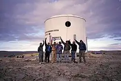 The completed exterior of the station on July 26, 2000. From left to right are Joe Amarualik, Joannie Pudluk, John Kunz, Frank Schubert, Matt Smola, Bob Nesson, and Robert Zubrin.