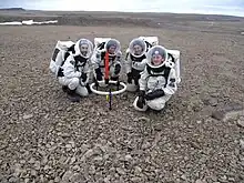 Crew members Brian Shiro, Christy Garvin, Stacy Cusack, and Kristine Ferrone deploy the TEM47-PROTEM low frequency electromagnetic survey equipment on Haynes Ridge during EVA 8.