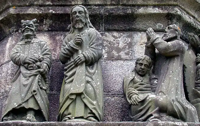 On the left is a depiction of Satan tempting Jesus and offering him bread. He has lifted his cloak and we can see his cloven feet. On the right is Jesus praying in the garden of Gethsemane. The apostle St John is fast asleep at his feet, his head cupped in his left hand. All the sculpture here is by Bastien Prigent although Yan Larhantec re-sculpted Satan's head.