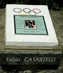 A memorial plaque with a photo in the middle