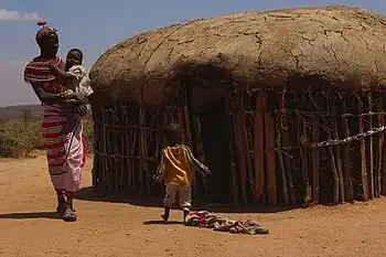 Family outside their hut in Umoja.