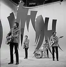 The Kinks miming a performance in a television studio.