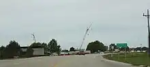 Sign on US 18, SWTC construction in background