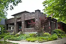 Exterior photo of Ferdinand N. Kahler home built in the Airplane Bungalow style on Cedar Bough Place, a private street in New Albany, Indiana.