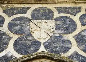 The canting arms of Sir Guy Ferre (d.1323): A fer de moline over all a bendlet, at Butley Priory, Suffolk