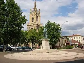 The church with a statue of Michel Combes in the foreground