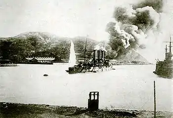 Pallada under fire as the Oil Depot burns