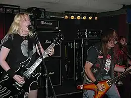 Fireball Ministry in 2004. L–R: Guitarist Emily Burton, vocalist/guitarist James A. Rota II, and bassist Janis Tanaka
