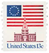1975 13¢ stamp features the Betsy Ross flag behind Independence Hall