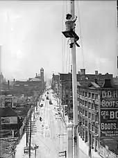 Flagpole painter with view looking west on Front Street