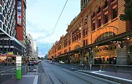 The facade as viewed from Flinders Street, showing tram lines
