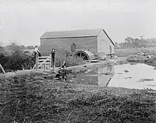 View of weir and mill with water wheel