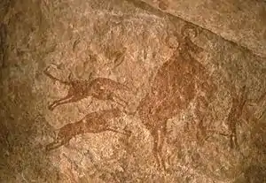 Image 44Petroglyph depicting two dogs hunting – Tassili n'Ajjer, Algeria (from Domestication of the dog)