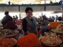 A food market in Uzbekistan, with markovcha in the center and funchoza on the right (2009)