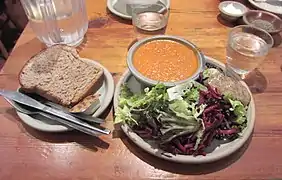 A lunch dish of soup and salad served on stoneware