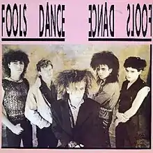 One of four album covers for Fools Dance. From left to right: Pete Gardner, Ron Howe, Gary Biddles, Simon Gallup, Stuart Curran.