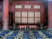 A room with blue patterned carpet and hanging dragon rug, Forbidden City, Beijing