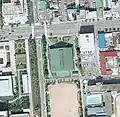 Aerial view of former Akita Municipal Gymnasium in 1975 (39°43′7.9″N 140°06′17.1″E﻿ / ﻿39.718861°N 140.104750°E﻿ / 39.718861; 140.104750)