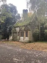 exterior of buff bricked building, in amongst foliage