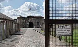 View of a fort in the distance with a chain-link fence to the left