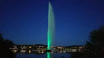 The fountain is bathed in green in Fountain Park with LED lights during holidays and special events. There are eight colors available to shine on the spray.
