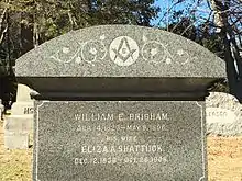 A late-19th-century headstone adorned with the Masonic square and compass