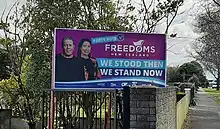 Photos of Brian Tamaki and Sue Grey on a large hoarding that says, "Party Vote Freedoms New Zealand. We stood then, we stand now".