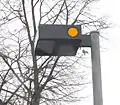 French street light with two amber flashing lights on its sides