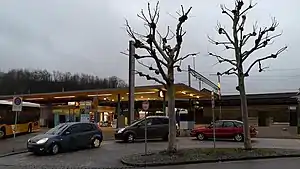 Cars pulled up in front of a platform with canopy