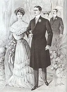 A black-and-white drawing of a white woman and white man getting married. The woman is wearing a white gown that is loose at the top, fitted at the waist, and loose to the ground with a small bustle at the rear. The man is wearing a long, black coat that fastens off-center and reaches just past his knees with slight waist definition. The sleeves of his jacket are slender but not tight and reach his wrists. Beneath this he has on a white shirt with a high collar, just visible beneath the coat's V-neck, and slim dark trousers over black shoes. The woman is wearing a veil over her hair but the man is not wearing a hat. There is a flower on his lapel, and the woman is holding a bouquet.