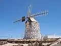 A stone-built windmill near the beach of La Oliva