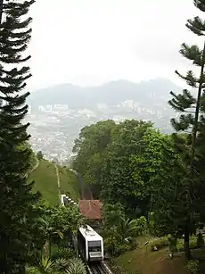 The 100-FUL Penang Hill new coach with view of the city in the background