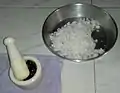 Grated coconut  (soy) and palm jaggery (mâddâcheñ godd) in mortar and pestle