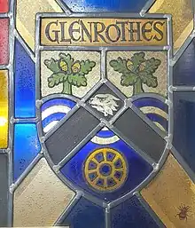 Former Coat of Arms of the Glenrothes Development Corporation enshrined in a stained glass window on display in the Rothes Halls in Glenrothes, Fife. The Coat of Arms depicts oak trees over the River Leven, the head of an otter within a chevron and the winding wheel of the former Rothes Colliery at the bottom.