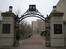 Open gateway with the letters G and W and the phrase "Professors Gate" visible on the arch